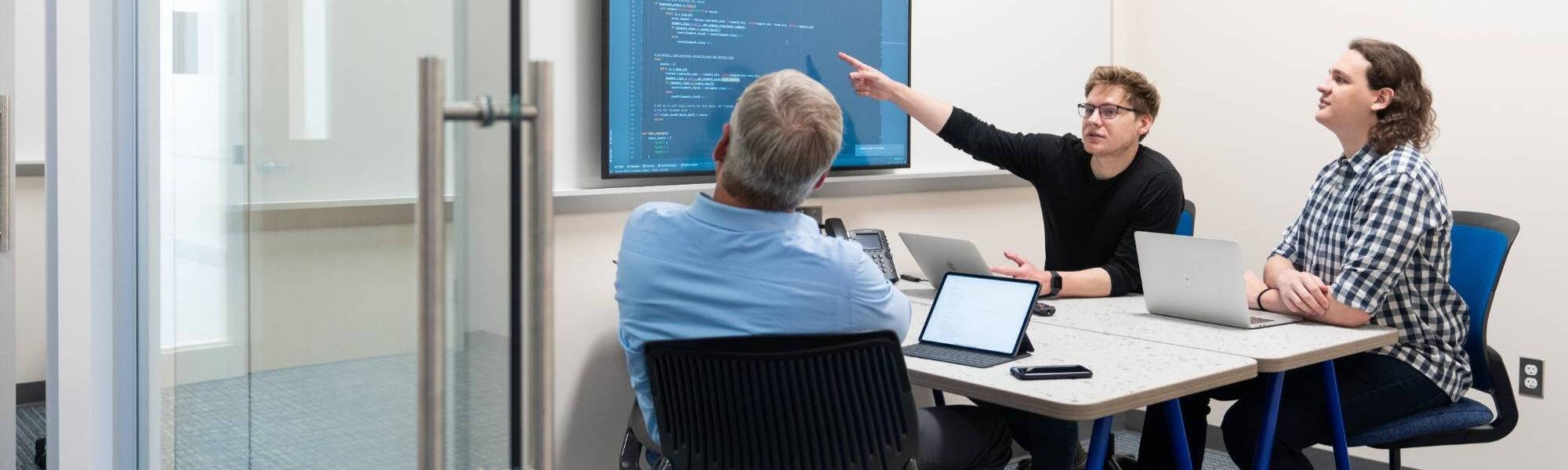Students work on a project in a conference room